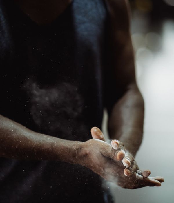 Man performing controlled strength exercise in a dark gym setting